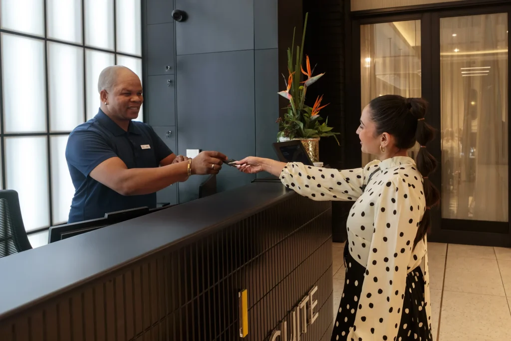 Guest receiving a room key at Station House reception