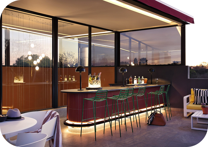 Rooftop bar and lounge at Home Suite Hotels Rosebank at dusk