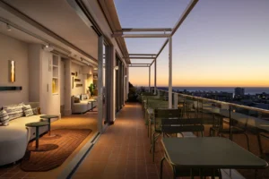 Rooftop terrace at Home Suite Hotels Sea Point at dusk, with lounge seating and views over Cape Town's Atlantic Seaboard