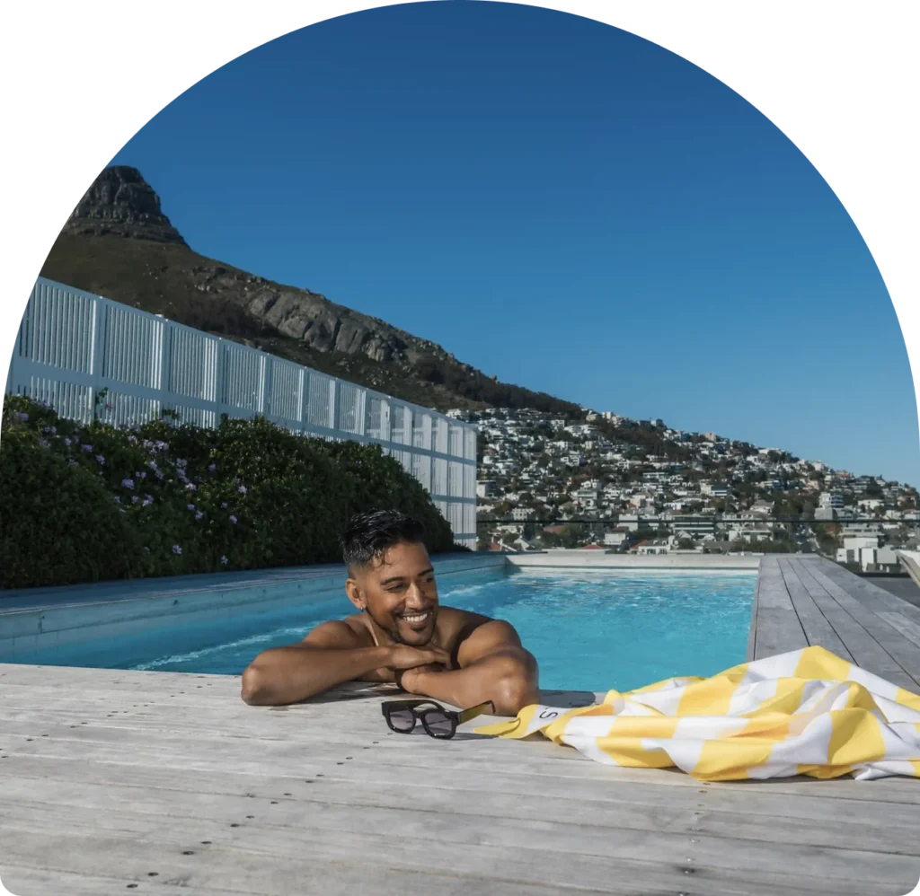 Guest relaxing in the rooftop pool at Station House, Sea Point